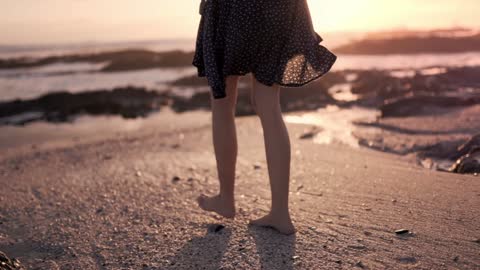 Woman Waking Barefooted On The Shore |