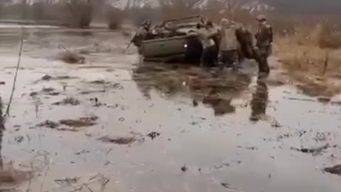 Ukrainian military's SUVs stuck in swamp in November's muddy conditions.