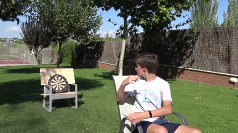 Guy Hits The Bullseye Throwing Dart Shot Backwards