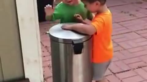 can out Kids Jokingly Hit Each Other With Trash Can's Lid