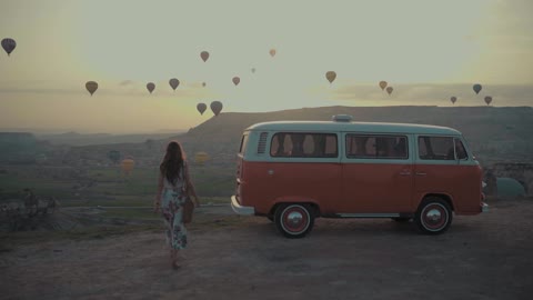 Great View of a Hot-Air Balloons In The Air And Woman Riding Her Vehicle