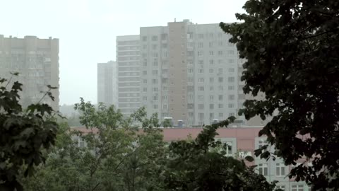 Bad weather over Apartment buildings and Raining