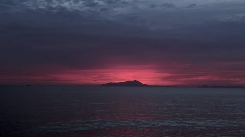 sea With View Of A Mountain At Sunset