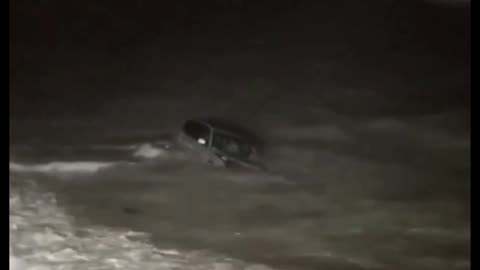 woman drives her car into the ocean in a high-speed police chase