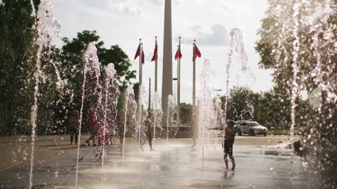 Children playing with fountains