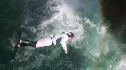 Man performs a crazy jump off a cliff .