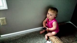 Toddler attempts to use TV remote