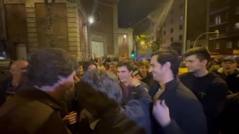 Spanish man shows his Tucker Carlson t-shirt as Tucker shakes hands and greets Madrid protesters.