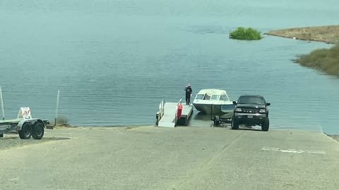 Driver Struggles to Back Boat Trailer into the Lake