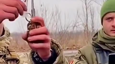 Ukrainian soldier preparing a grenade on the drone