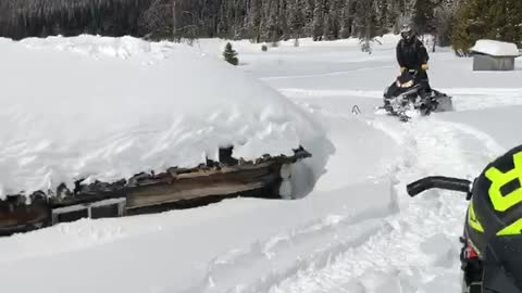 Jumping Snowmobile off Cabin Roof