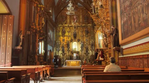 Interior of a baroque church with statues and gilt details