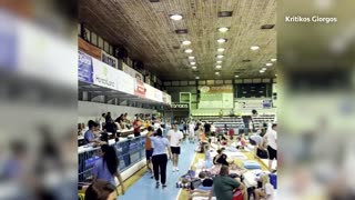 Greece wildfire evacuees camp on basketball court