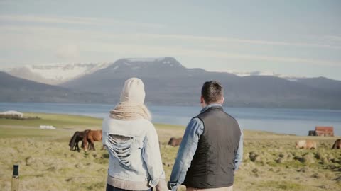 Back view of young tourists couple standing on the Iceland