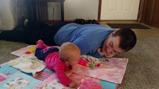 Adorable baby girl laughs at dad crawling