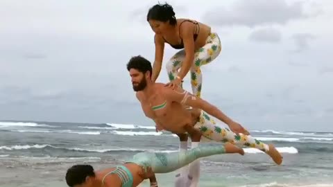 Group of Friends Do Acroyoga at the Beach