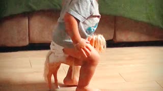 Toddler Tries His Best to Ride Small Horse Toy