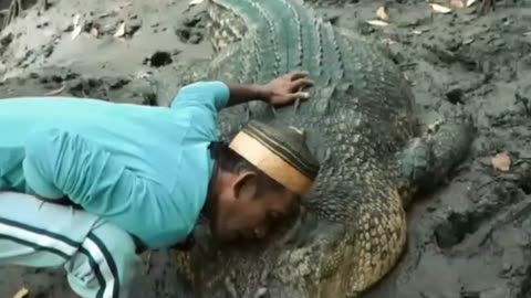 This man from Kalimantan hugs a wild crocodile