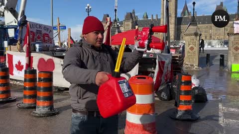 Canadian protester drinks from gas can