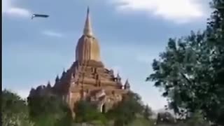 (V)SHAPED UFO FLYING OVER A BUDDHIST TEMPLE