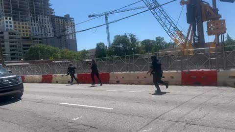 Police officers seen running with guns after shelter in place order lifted in Midtown Atlanta