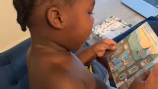 2 year old reads a book