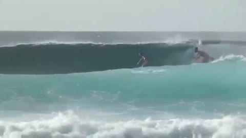 Surfer Pushed A Man Off His Surfboard While Riding A Wave