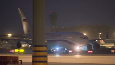 Russia's President, Vladimir Putin, visiting China; his plane lands there