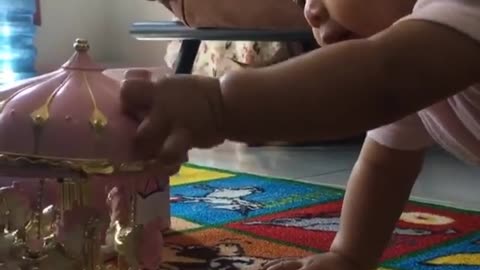 Cat Watching A Small Baby Playing With Her Toy
