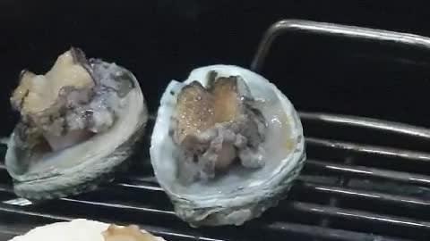 Abalone dancing on a fire plate