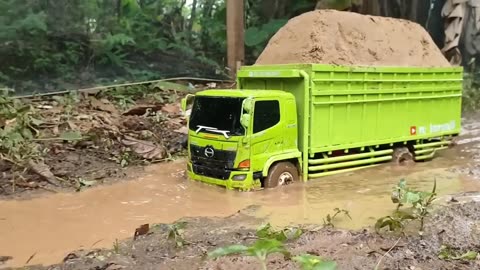 Remote control dump truck picks up a load of sand