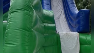 Kid Accidentally Front Flips Down Bouncy Slide