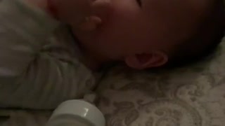 Baby boy is sucking a sock
