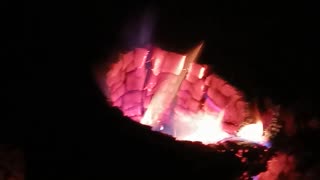 A Wood Stove Burning A Holey Oak Log