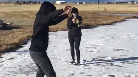 Guy black sweater slides on ice falls
