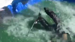 Skier tries to do a jump over pool, trips over ramp and falls into the water