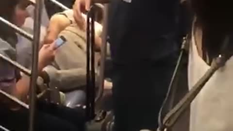 Man asleep on crowded subway train