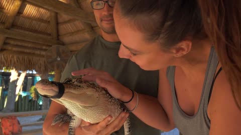 Couple Holding Cute Baby Alligator
