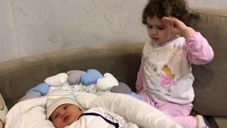 Baby girl adorably takes care of her little brother