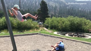 Boy in blue jumps off swing falls off
