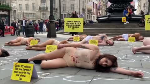 Animal rights activists stage 'crime scene' protest in London's Piccadilly Circus