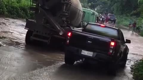 Truck Driver helping a pick up truck