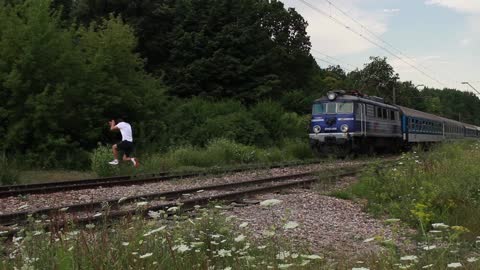 Crazy Kid Jumps In Front Of Moving Train