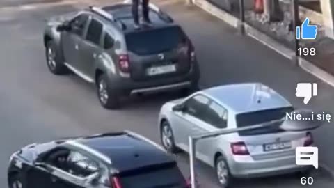 African jumps on cars outside of BMW dealership in Warsaw