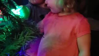 Little boy completely fascinated by Christmas lights