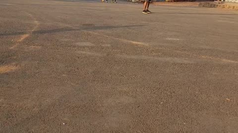 A random guy playing football on the street