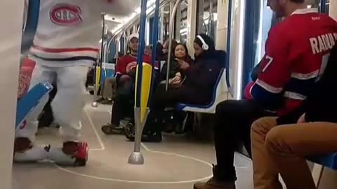 Man white hockey uniform on hover board on train