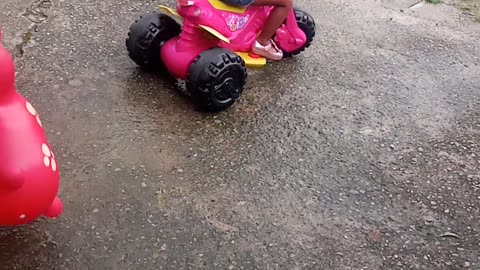 my daughter riding a velotrol