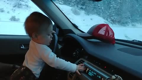 Baby laughing at windshield wipers in the snow