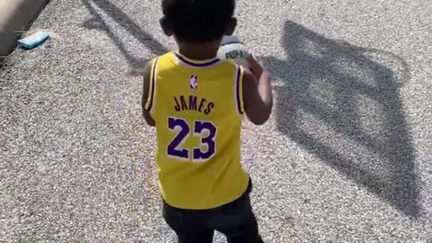 Toddler Drills A Long Distance Basketball Shot With Ease